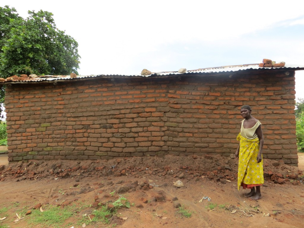 Amina Sumani showing part of the wall that was rebuilt by the group