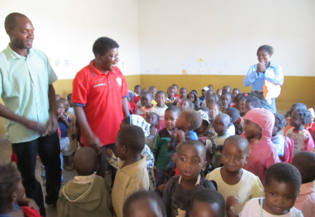 Mr. Munthali (L) and Mr. Murowa (R) with the nursery  school kids at St. John's in Mpulula