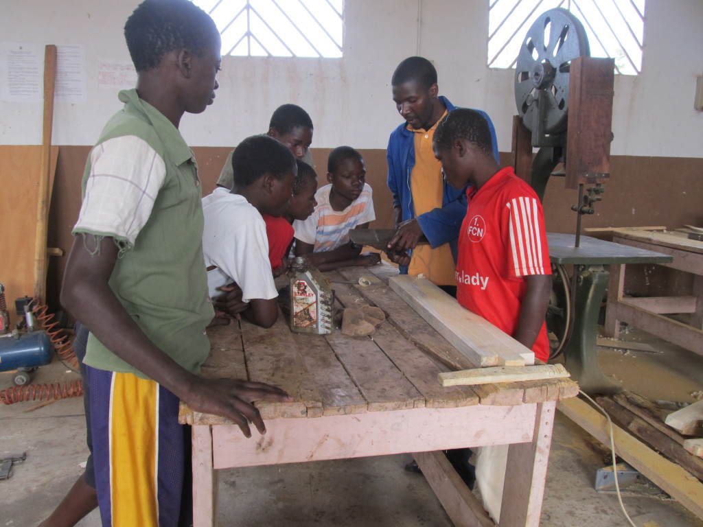     Mr. July teaching the trainees some skills in planing 