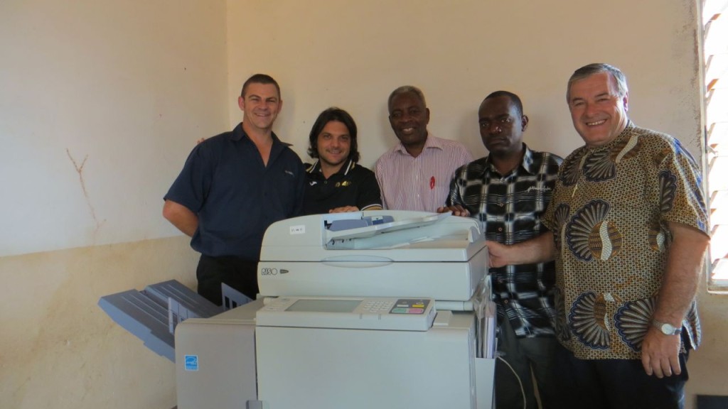 Fr. Mario (R) and Alessandro Marchetti (2nd from L) pose with the technicians